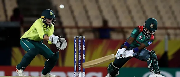 Rumana Ahmed of Bangladesh plays a reverse sweep, as Faye Tunnicliffe of South Africa looks on during the ICC Women's World T20 2018 match between South Africa and Bangladesh at Darren Sammy Cricket Ground on November 18, 2018.