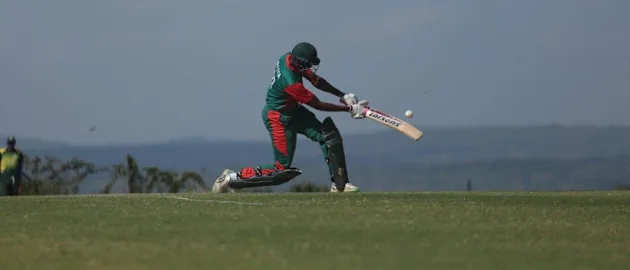 Collins Obuya powers a six for Kenya against Rwanda
