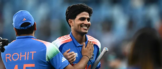 India's Shubman Gill (R) is congratulated by his team captain Rohit Sharma at the end of the ICC Champions Trophy 