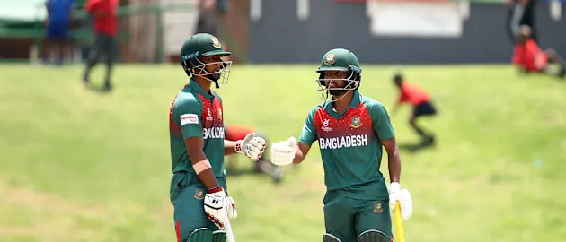 Mohammad Tawhid Hridoy of Bangladesh and Shahadat Hossain of Bangladesh celebrate a half century partnership.