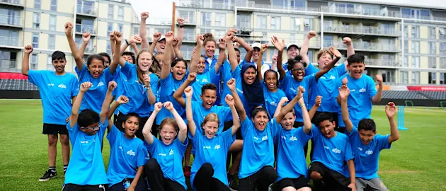 Schoolchildren pose alongside members of the Australian side for a group photo during the ICC Cricket for Good - Australia event at the Brightside Ground