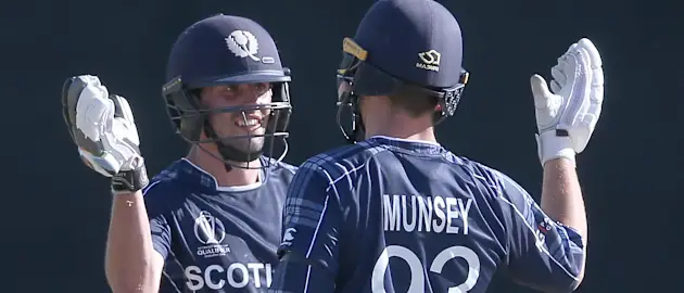 Calum MacLeod (L) celebrates with George Munsey of Scotland after reaching his 150 during the ICC Cricket World Cup Qualifier between Afghanistan and Scotland at  the BAC Stadium  on March 4, 2018 in Bulawayo, Zimbabwe.