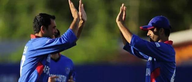 54678 Afghan bowler Mohammad Nabi (L) celebrat