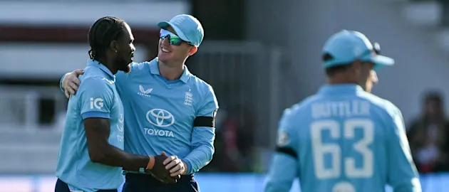 England's Jofra Archer (L) celebrates with England's Harry Brook (2nd L) after the dismissal of India's KL Rahul (not pictured) during the third one-day international (ODI) cricket match between England and India