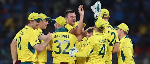 Josh Hazlewood of Australia celebrates with teammates after taking the wicket of Shreyas iyer of India during the ICC Men's Cricket World Cup India 2023 between India and Australia 