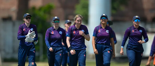 Scotland players celebrate after taking a wicket