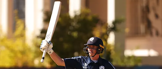 Brandon McMullen of Scotland raises his bat after scoring a half century during the ICC Men's Cricket World Cup Qualifier Zimbabwe 2023 match between the Scotland and Oman at Bulawayo Athletic Club on June 25, 2023 in Bulawayo, Zimbabwe.