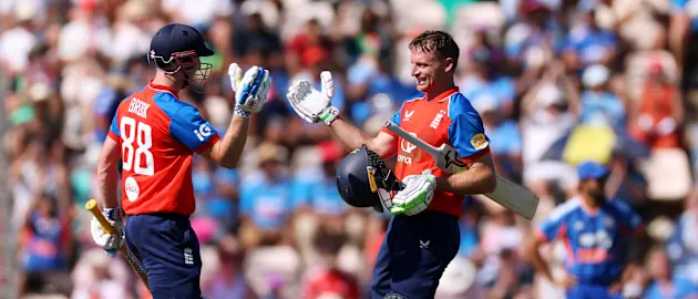 Jos Buttler of England is congratulated by Harry Brook as he celebrates reaching his century during the 5th Vitality IT20 match between England and India at Utilita Bowl on July 11, 2026 in Southampton, England. 