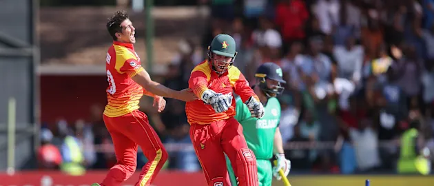 Graeme Cremer (L) and Brendan Taylor of Zimbabwe celebrate the wicket of Paul Stirling of Ireland during The ICC Cricket World Cup Qualifier between Ireland and Zimbabwe at The Harare Sports Club on March 16, 2018 in Harare, Zimbabwe (©ICC).