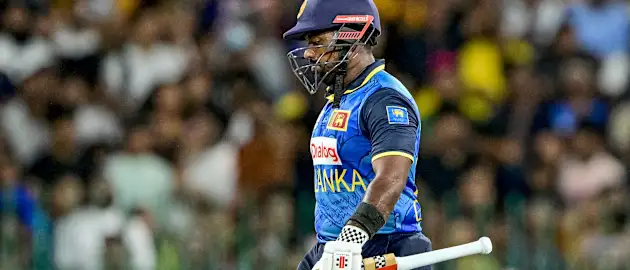Sri Lanka's captain Charith Asalanka walks back to the pavilion after his dismissal