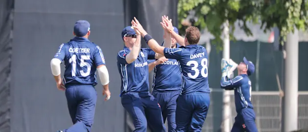 Scotland celebrate a wicket.