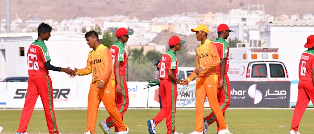 Oman and Bhutan players walking off the field