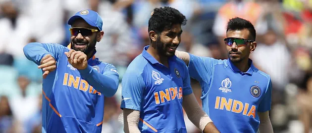 Jasprit Bumrah (C) celebrates with India's captain Virat Kohli (L) after taking the wicket of New Zealand's Colin Munro for four runs during the 2019 Cricket World Cup warm up match between India and New Zealand at The Oval in London on May 25, 2019.