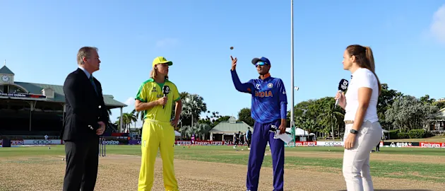 Yash Dhull of India flips the coin as Cooper Connolly of Australia looks on ahead of the ICC U19 Men's Cricket World Cup Super League Semi Final 2 match between India and Australia at Coolidge Cricket Ground on February 02, 2022 in Antigua.