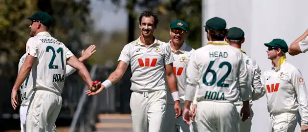  Australia's Mitchell Starc (C) celebrates with team mates after bowling Bangladesh's Mominul Haque during the second day of the second cricket Test match between Australia and Bangladesh at the Great Barrier Reef Stadium in Mackay on August 23, 2026.