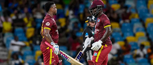 Shimron Hetmyer (L) and Sherfane Rutherford (R) of West Indies chat after reaching 50 runs partnership