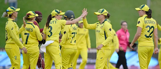 Jess Jonassen of Australia celebrates with teammate Megan Schutt after catching out Stafanie Taylor of the West Indies and to win the 2022 ICC Women's Cricket World Cup match between Australia and the West Indies at Basin Reserve on March 30, 2022.