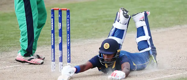 Dhananjaya Lakshan of Sri Lanka dives to make his ground