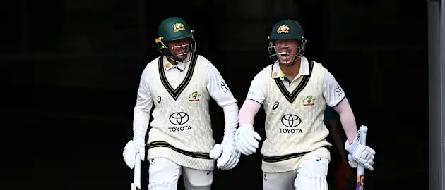 Usman Khawaja and David Warner of Australia share a laugh as they take to the field during day three of the Second Test Match between Australia and Pakistan