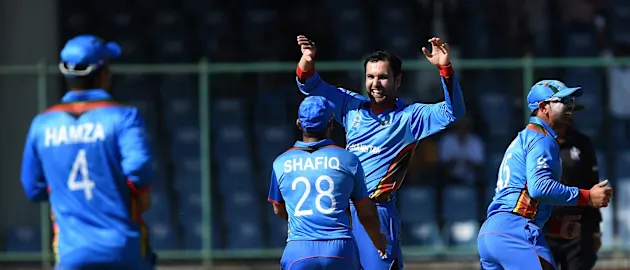 Mohammad Nabi (second from left) performed with bat and ball to help Afghanistan to a resounding win.