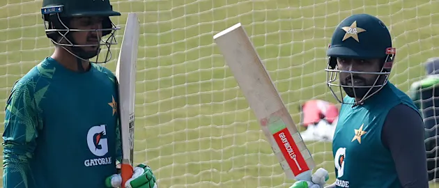 Ayub (left) receives some advice at training from former captain Babar Azam // Getty Images