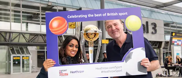 Phil Tufner with Isa Guha at the ICC Men’s Cricket World Cup 2019 Trophy Tour at Heathrow airport