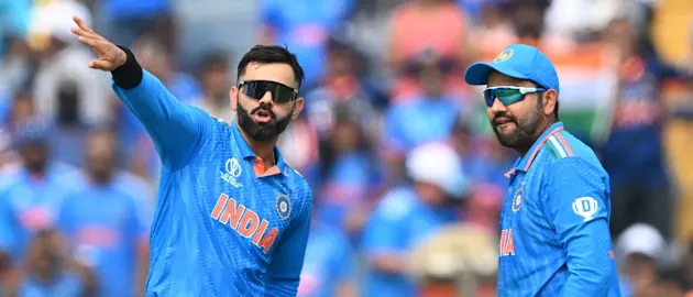 India's Virat Kohli (L) speaks with captain Rohit Sharma during the 2023 ICC Men's Cricket World Cup one-day international (ODI) match between India and Bangladesh