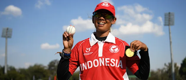 Ni Luh Ketut Dewi of Indonesia poses with the Player of the Match award and the match ball after taking five wickets following the ICC Women's U19 T20 World Cup 2023 4th place playoff match between Zimbabwe and USA at Willowmoore Park on January 20, 2023.