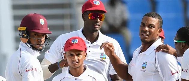 Windies celebrate the wicket of Mominul Haque