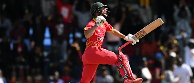 Sean Williams of Zimbabwe celebrates their century during the ICC Men's Cricket World Cup Qualifier Zimbabwe 2023 Super 6 match between Zimbabwe and Oman at Queen’s Sports Club on June 29, 2023 in Bulawayo, Zimbabwe.
