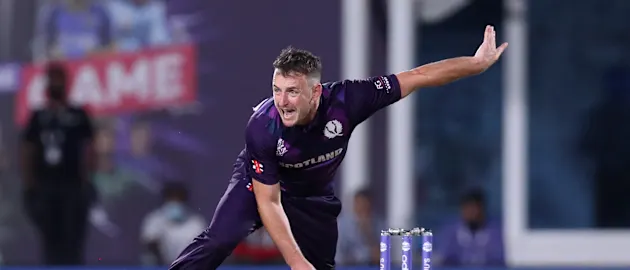 Scotland's Chris Greaves bowls during the ICC mens Twenty20 World Cup cricket match between Bangladesh and Scotland at the Oman Cricket Academy Ground in Muscat on October 17, 2021.