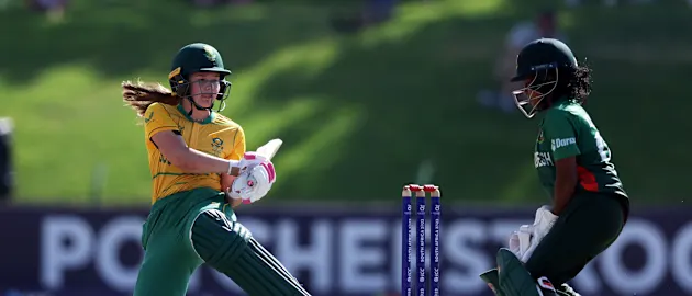 Madison Landsman of South Africa plays a shot as Dilara Akter of Bangladesh looks on during the ICC Women's U19 T20 World Cup 2023 Super 6 match between Bangladesh and South Africa at JB Marks Oval on January 21, 2023 in Potchefstroom, South Africa.