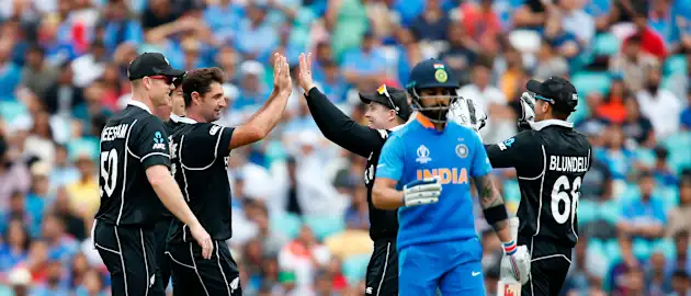New Zealand's Colin de Grandhomme (2L) celebrates bowling India's Captain Virat Kohli (2R) for 18 runs during the 2019 Cricket World Cup warm up match between India and New Zealand at The Oval in London on May 25, 2019.