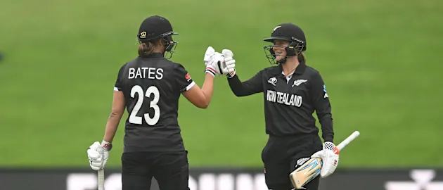 Suzie Bates of New Zealand is congratulated by teammate Amelia Kerr