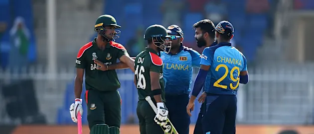 Lahiru Kumara of Sri Lanka clashes with Liton Das of Bangladesh following the wicket during the ICC Men's T20 World Cup match between Sri Lanka and Bangladesh at Sharjah Cricket Stadium on October 24, 2021 in Sharjah, United Arab Emirates.