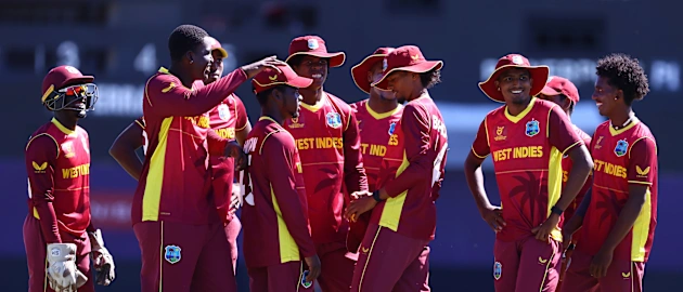 Players of West Indies huddle as they celebrate the wicket of Lyle Robertson of Scotland during the ICC U19 Men's Cricket World Cup match between West Indies and Scotland at Warner Park Sporting Complex on January 17, 2022 in Basseterre.