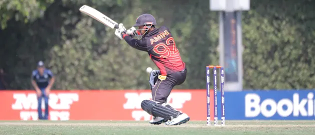 Charles Amini hits a boundary.