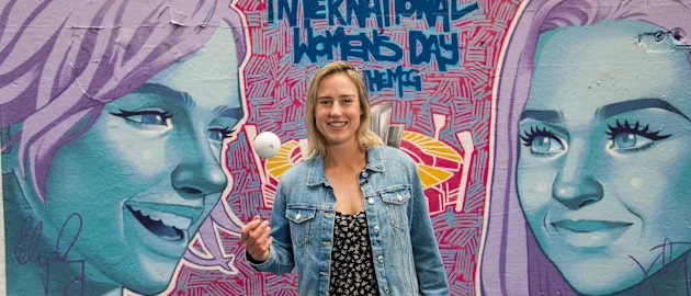 Ellyse Perry in front of finished mural