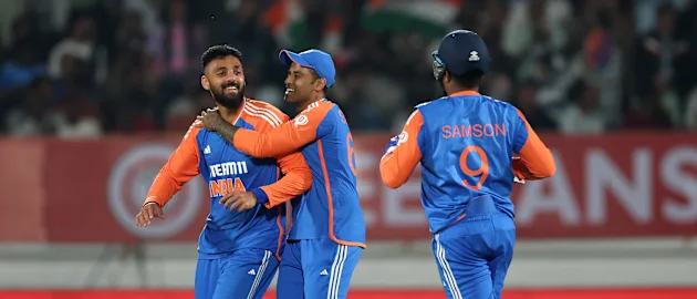 Varun Chakaravarthy celebrates with skipper Suryakumar Yadav