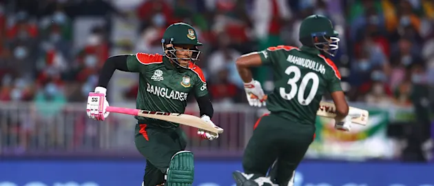 Mushfiqur Rahim and Mahmudullah of Bangladesh run between the wickets during the ICC Men's T20 World Cup match between Bangladesh and Oman at Oman Cricket Academy Ground on October 19, 2021 in Muscat, Oman.