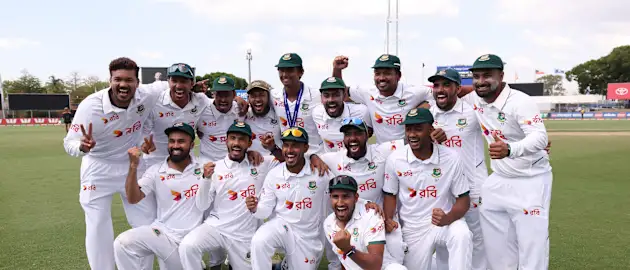 Bangladesh players pose for a team photo after Bangladesh defeated Australia on day four of the First Test Match