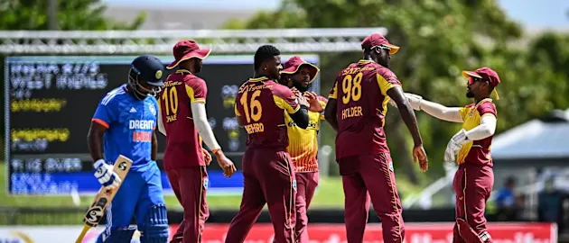 West Indies players celebrate the wicket of Sanju Samson // Getty Images