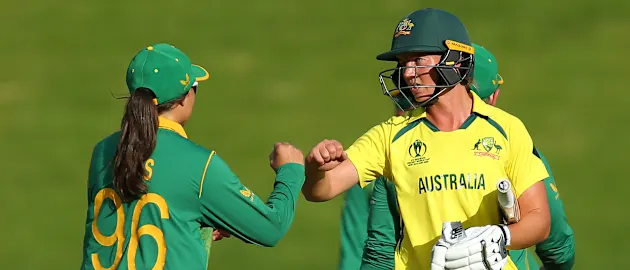 Meg Lanning of Australia is congratulated by Sune Luus of South Africa