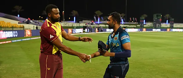 Kieron Pollard of West Indies and Dasun Shanaka of Sri Lanka shake hands following the ICC Men's T20 World Cup match between West Indies and Sri Lanka at Sheikh Zayed stadium on November 04, 2021 in Abu Dhabi, United Arab Emirates.