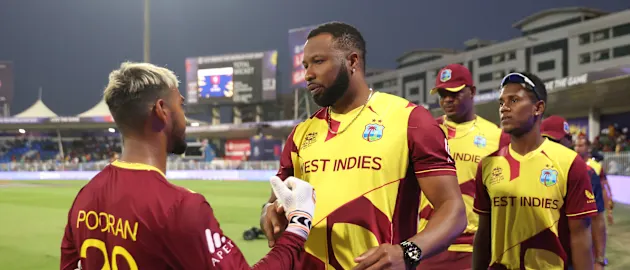 Nicholas Pooran and Kieron Pollard of West Indies interact following the ICC Men's T20 World Cup match between West Indies and Bangladesh at Sharjah Cricket Stadium on October 29, 2021 in Sharjah, United Arab Emirates.