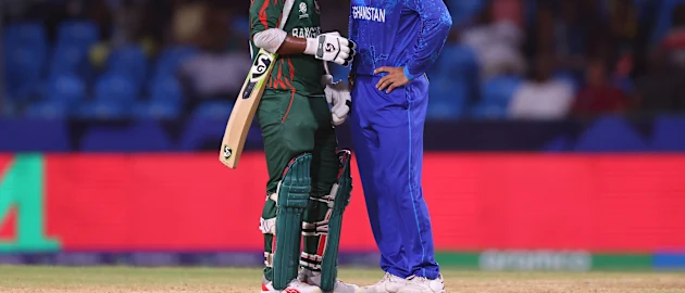 Litton Das of Bangladesh and Rashid Khan of Afghanistan interact between wickets during the ICC Men's T20 Cricket World Cup
