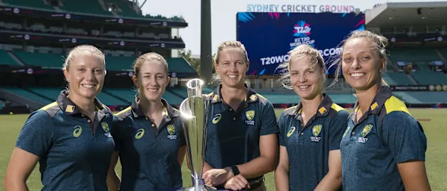 Members of the Australia Women's team pose with the ICC T20 World Cup 2020 trophy during the fixture announcement event