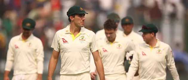 Pat Cummins of Australia leads the team off the ground after they were defeated by India