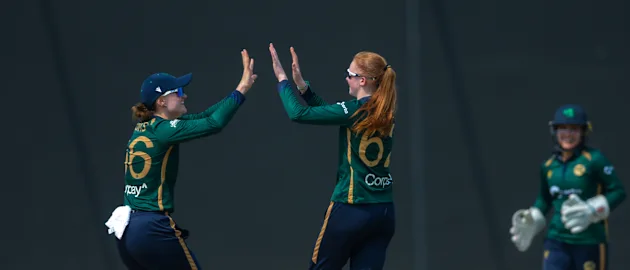 Kia McCartney (right) takes her first international wicket
