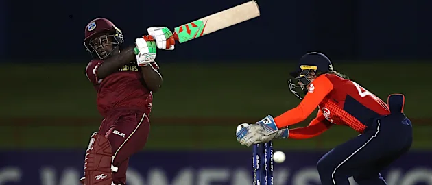 Deandra Dottin of WiIndies pulls the ball towards the boundary, asAmy Jones of England looks on during the ICC Women's World T20 2018 match between Windies and England at Darren Sammy Cricket Ground on November 18, 2018 in Gros Islet, Saint Lucia.
